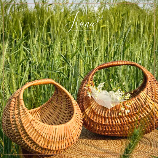 Two woven baskets with flowers in a field of green wheat.